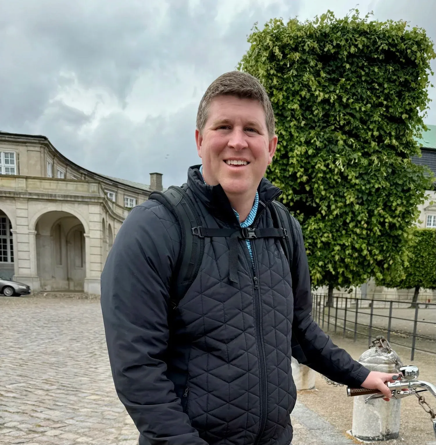 Chad Tyler smiling outdoors in a black jacket
